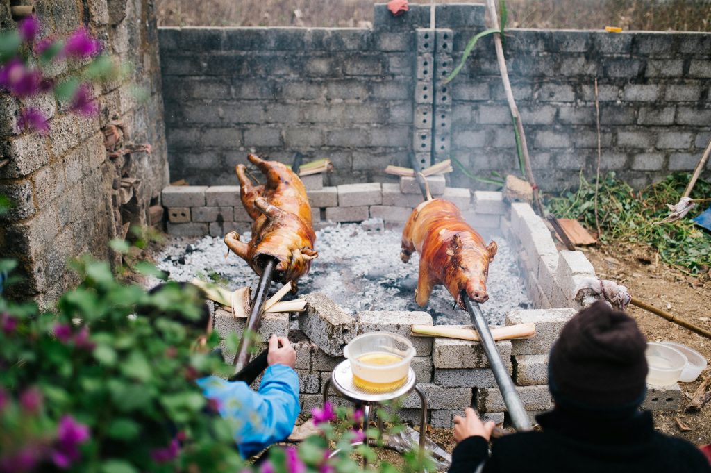 Authentic pig roasting scene in Lạng Sơn, Vietnam, showcasing cultural culinary techniques.